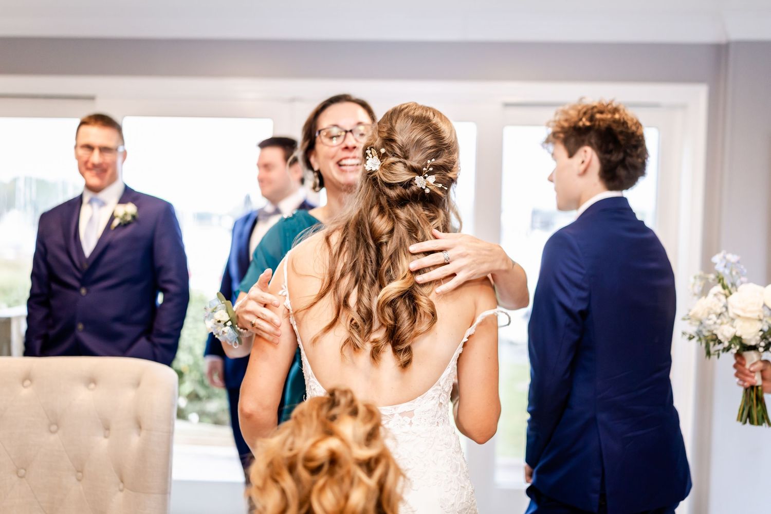 Wedding reception venue with guests mingling in an elegant indoor space.