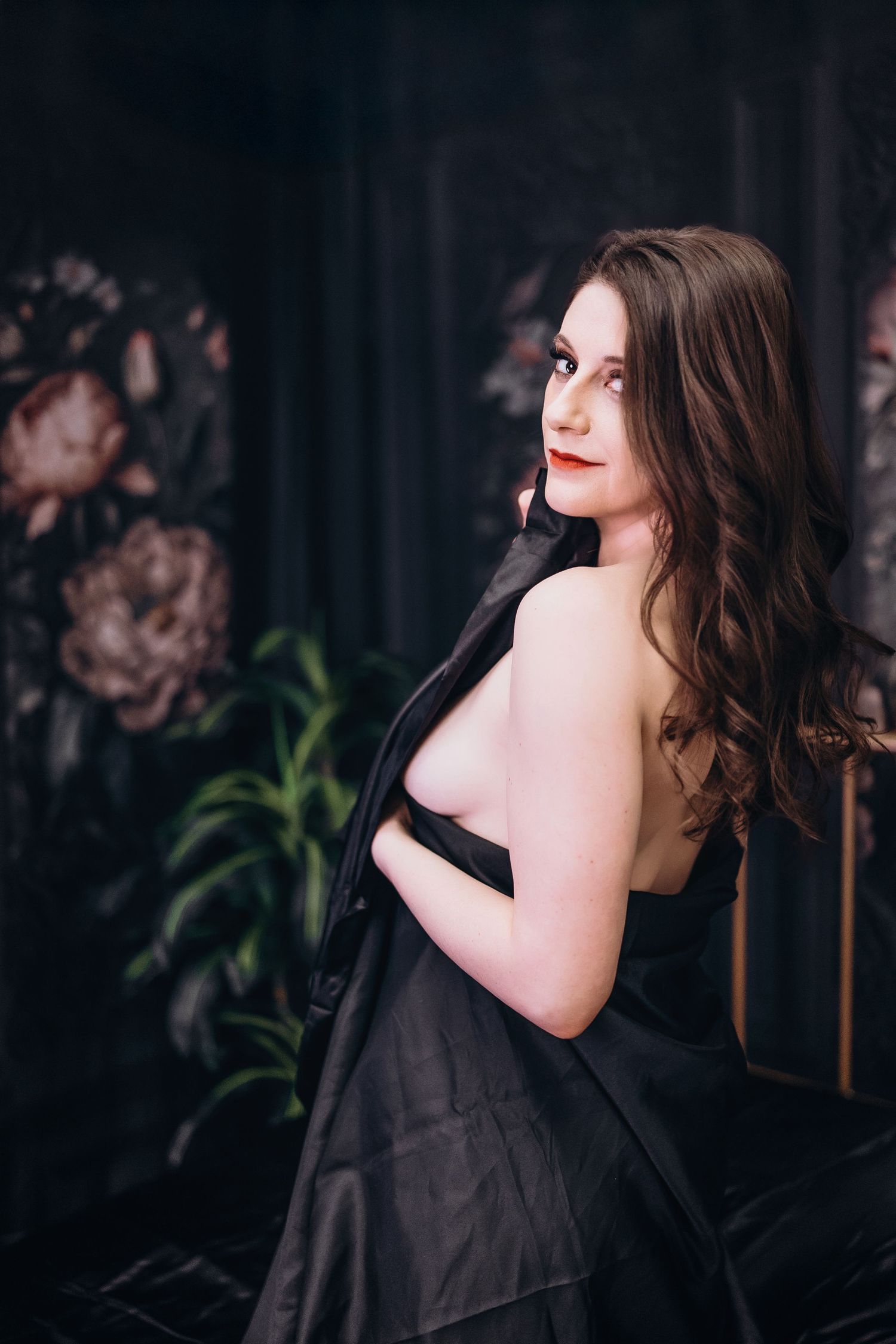 A series of artistic portraits showing a person in a black dress against a dark background with subtle lighting.