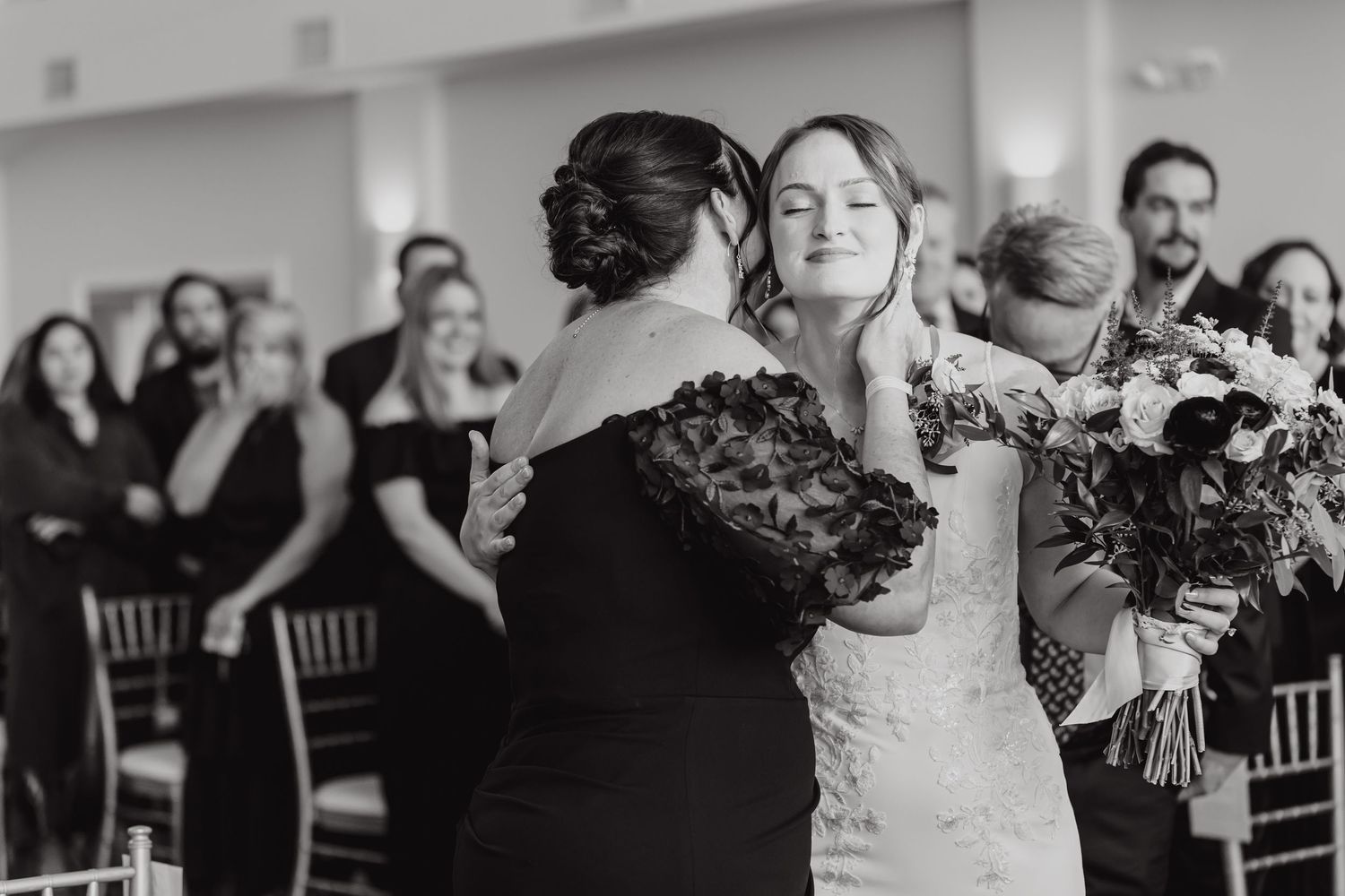 Black and white shots of wedding guests reacting emotionally during the ceremony.