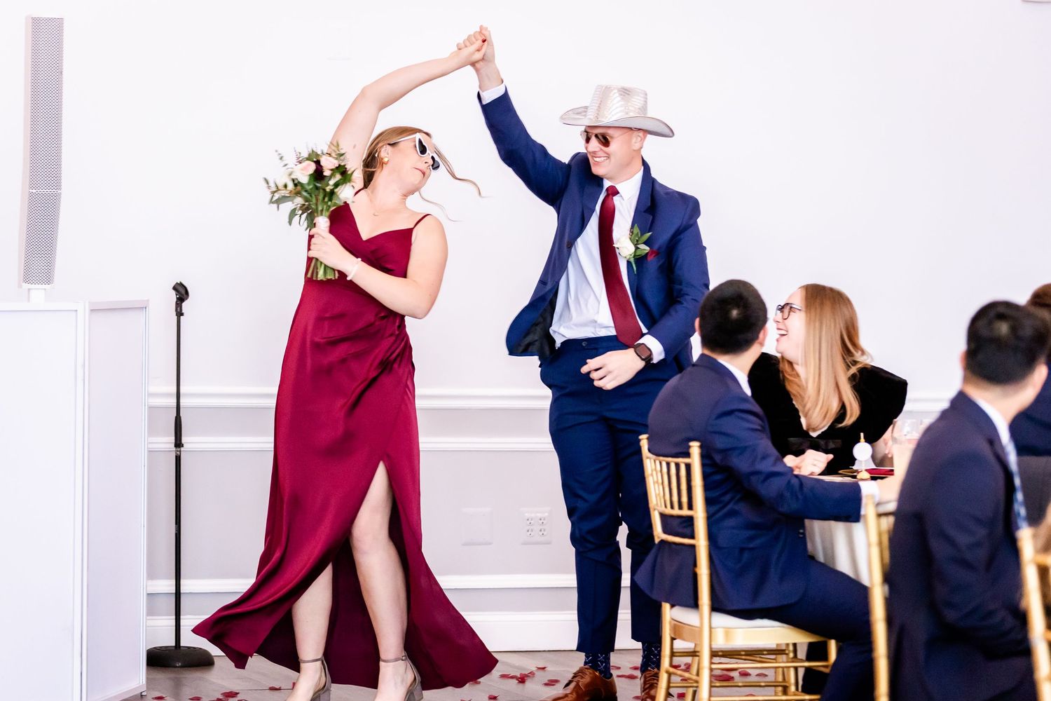Wedding party celebrates during reception with dancing and joyful moments.