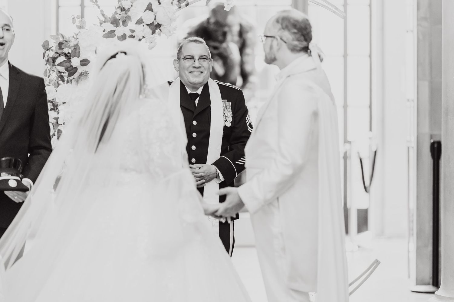 Vintage black and white photo of wedding ceremony with officiant and couple at altar.