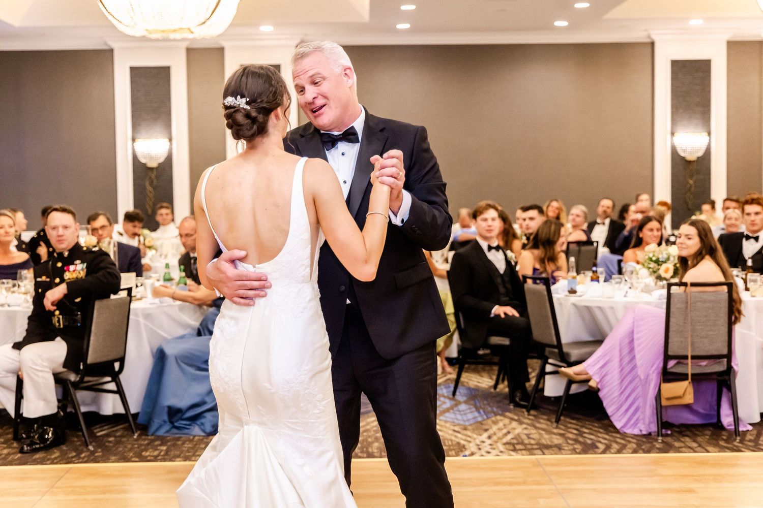 Wedding reception dance floor filled with guests celebrating.