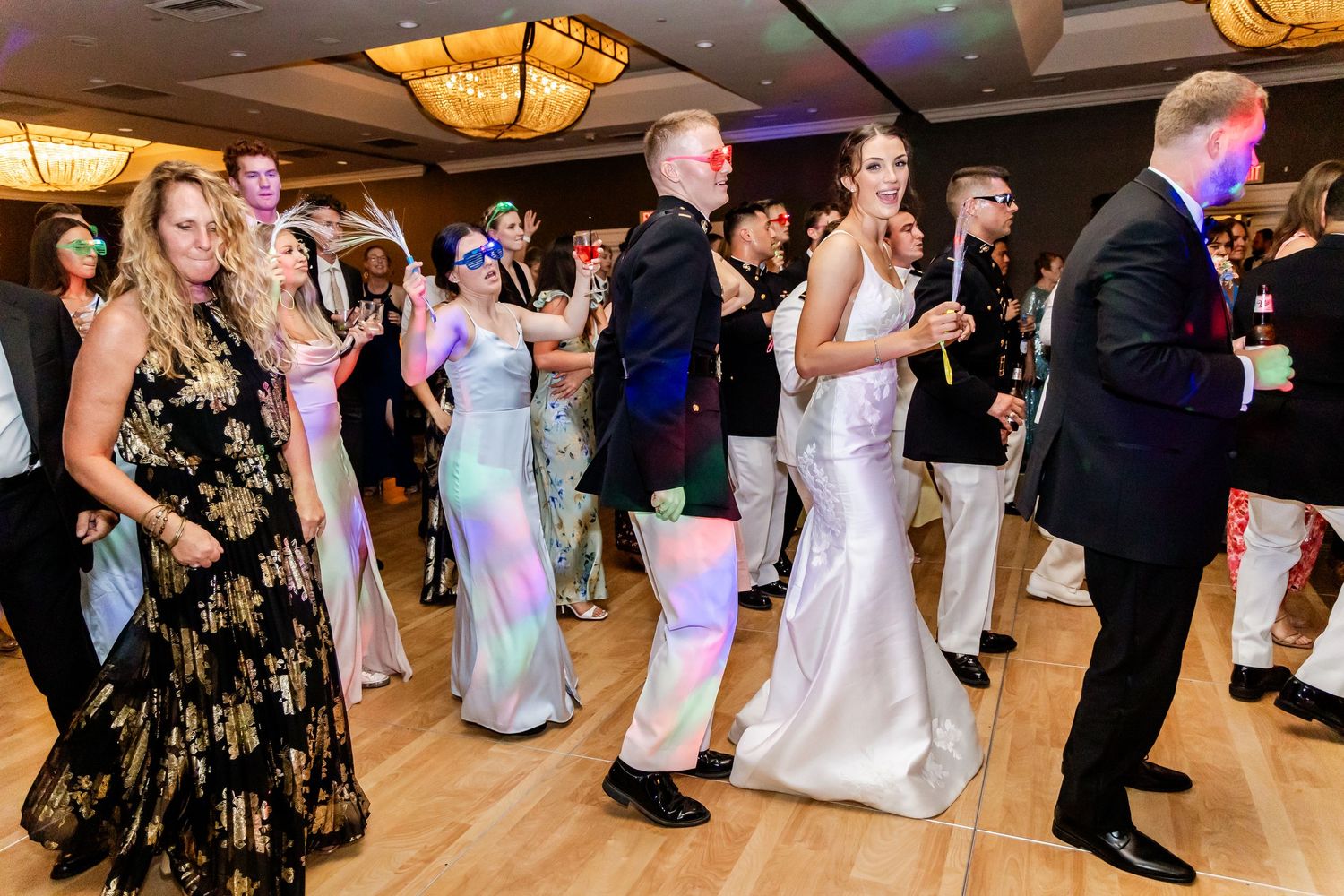 Wedding reception dance floor filled with guests enjoying the celebration.