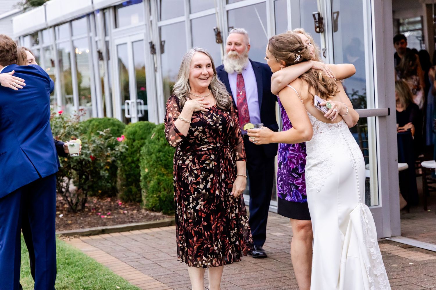 Wedding guests celebrating and sharing joyful moments at an outdoor venue.