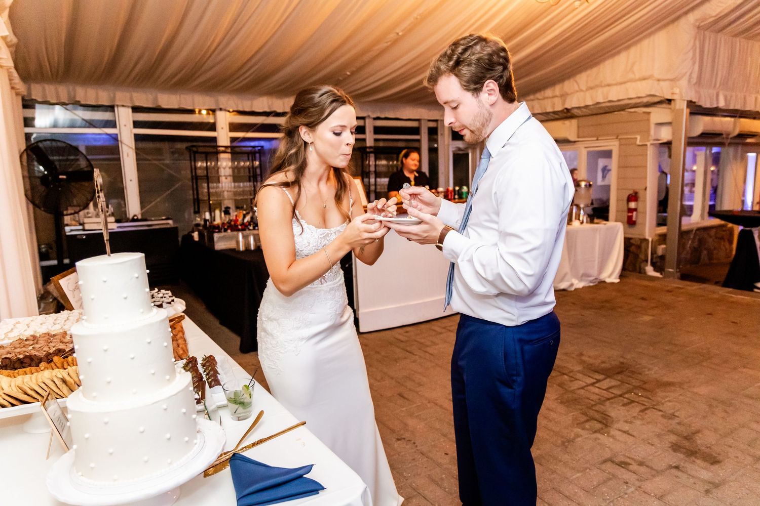 Wedding reception candid moments with guests dancing and celebrating in decorated venue.