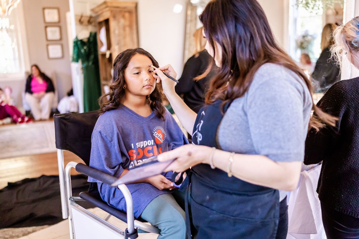 Makeup artists prepare a bride and bridesmaids for a wedding day celebration.