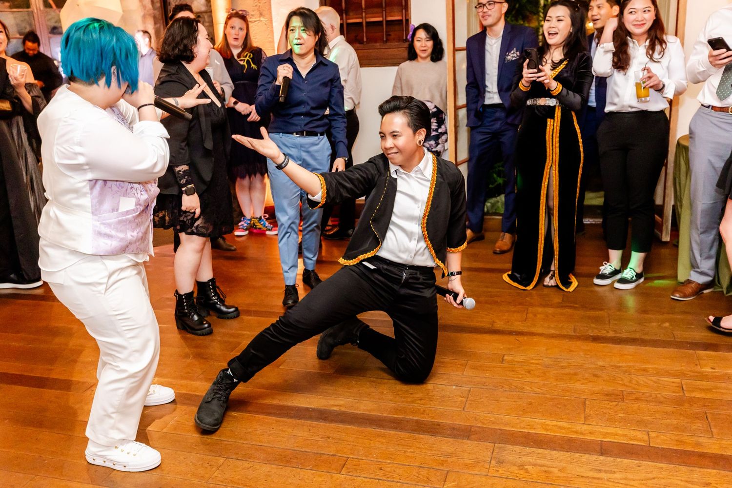 Dynamic dance moves being performed during an energetic wedding reception celebration.