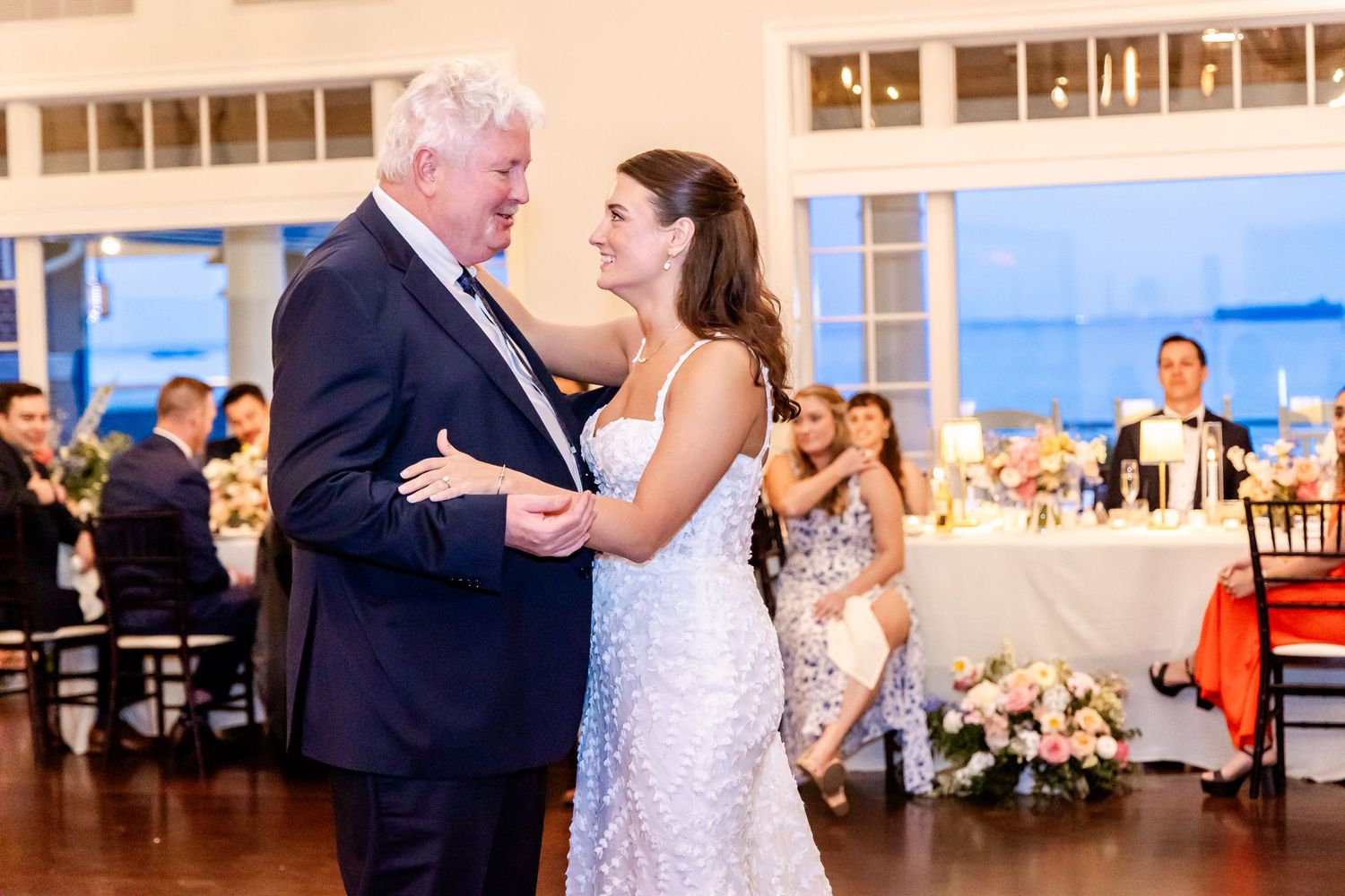 A tender dance moment captured during a wedding reception in an elegant ballroom.