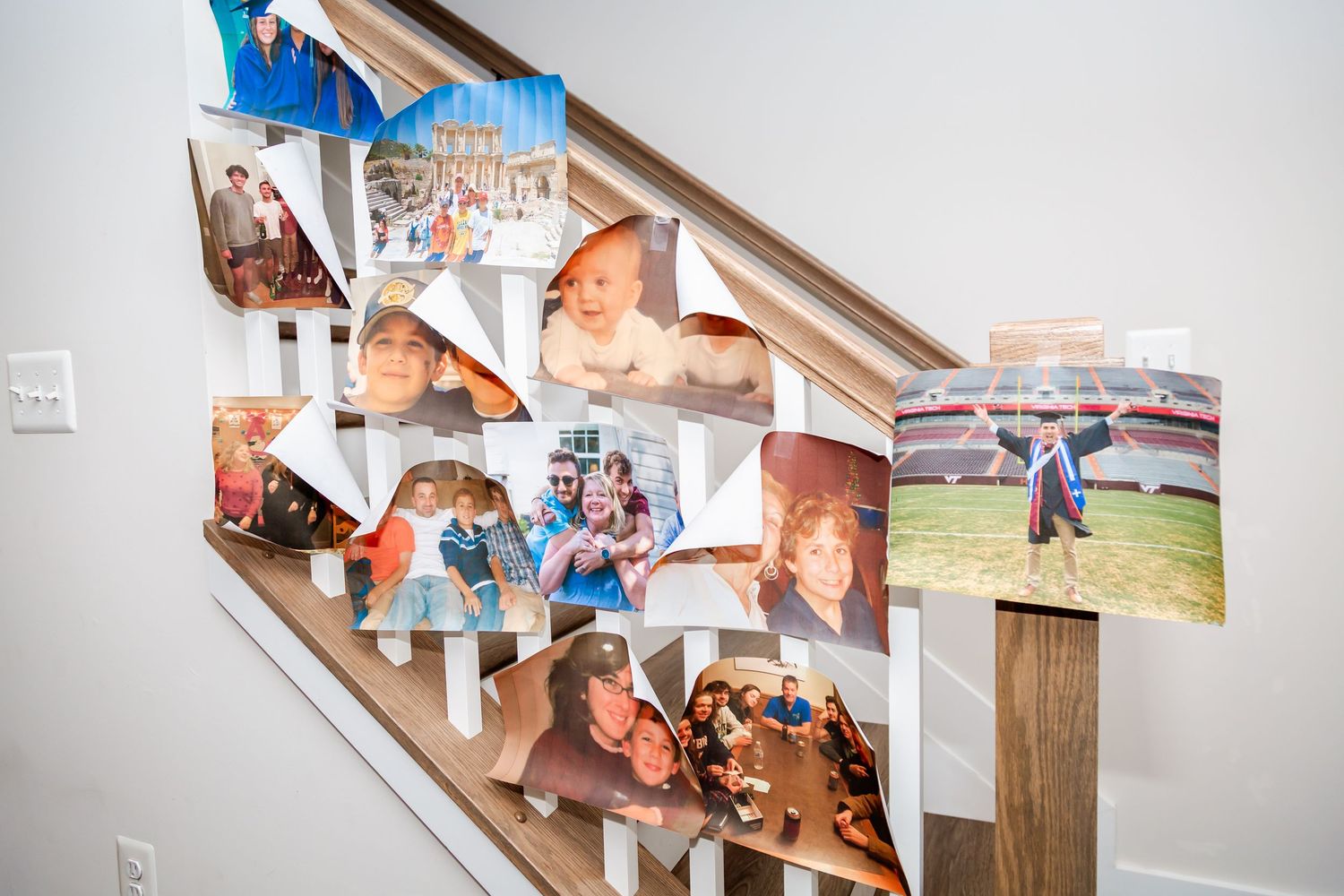 Collection of personal photos and memories displayed on a wall at a wedding.