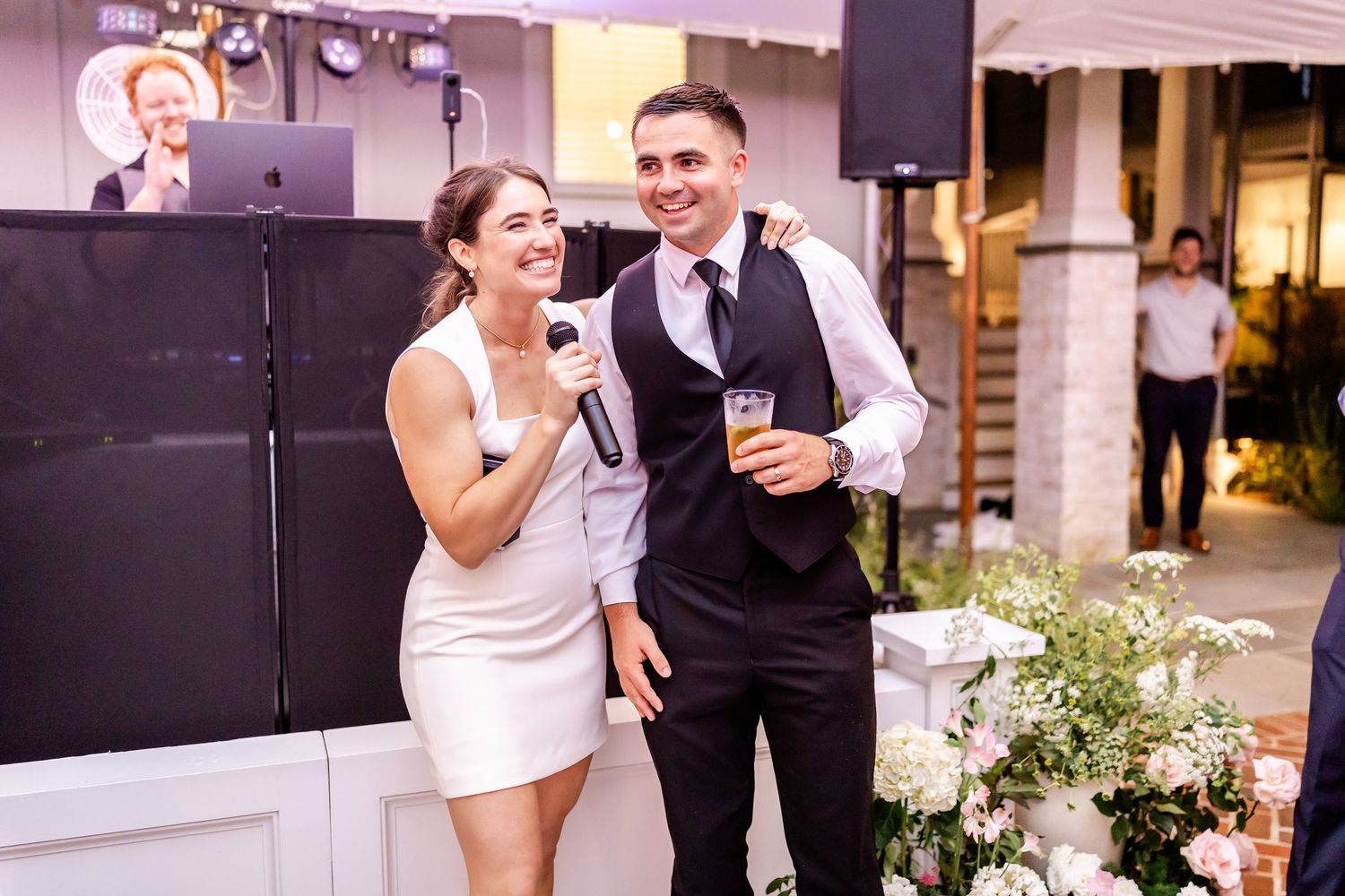 A wedding couple shares a joyful moment together during their celebration outdoors.