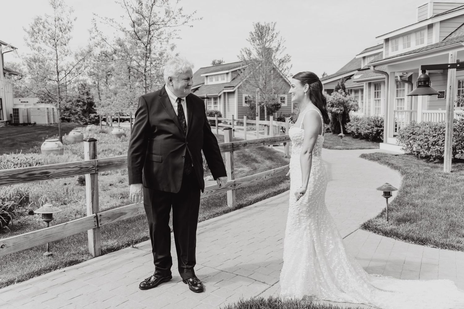 Black and white wedding photos showing couple walking together on outdoor path.