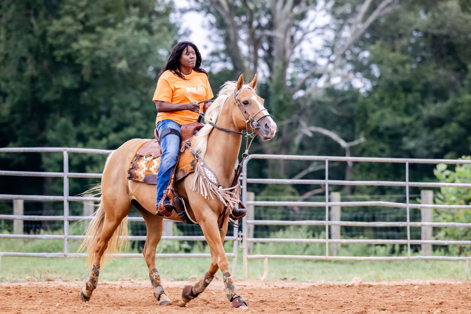 Horses and riders compete in barrel racing, sprinting between barrels on a sunny afternoon.