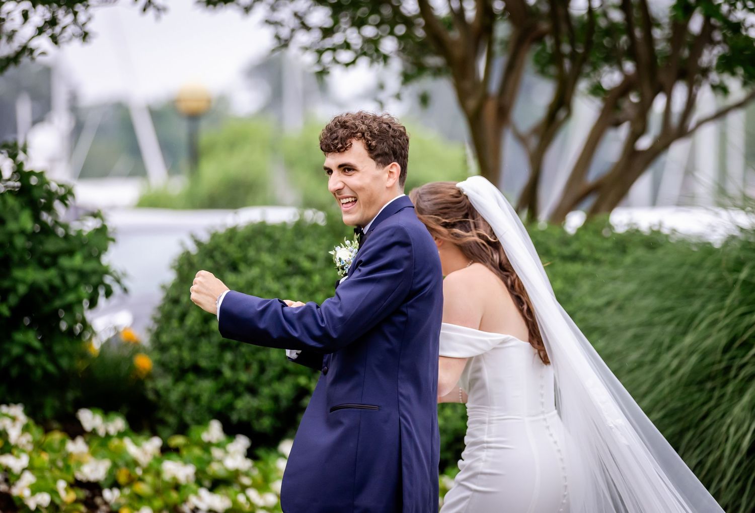 Romantic wedding couple sharing a moment in a garden setting.