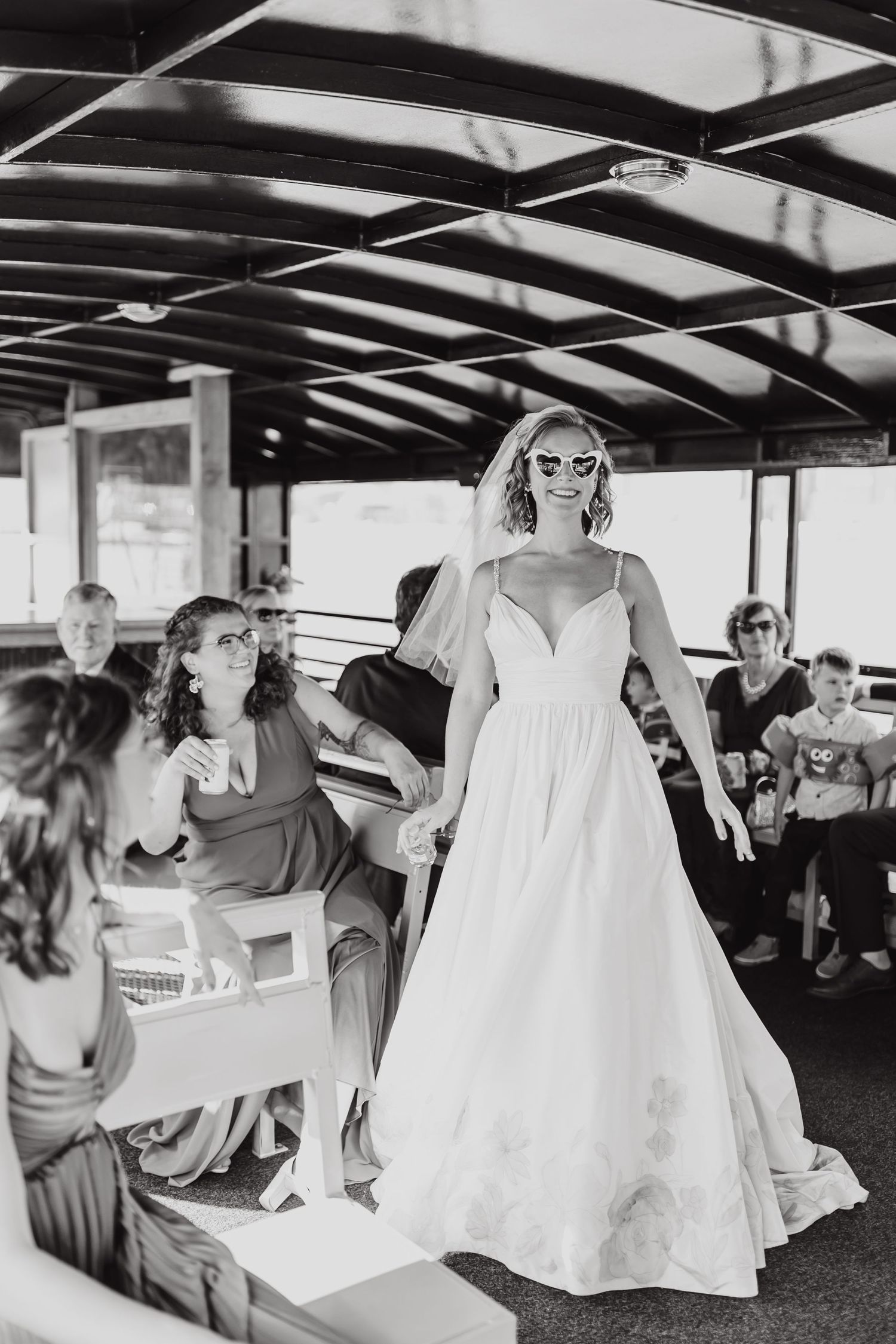 A sequence of four black and white photos showing wedding preparations with bridesmaids in white dresses getting ready.