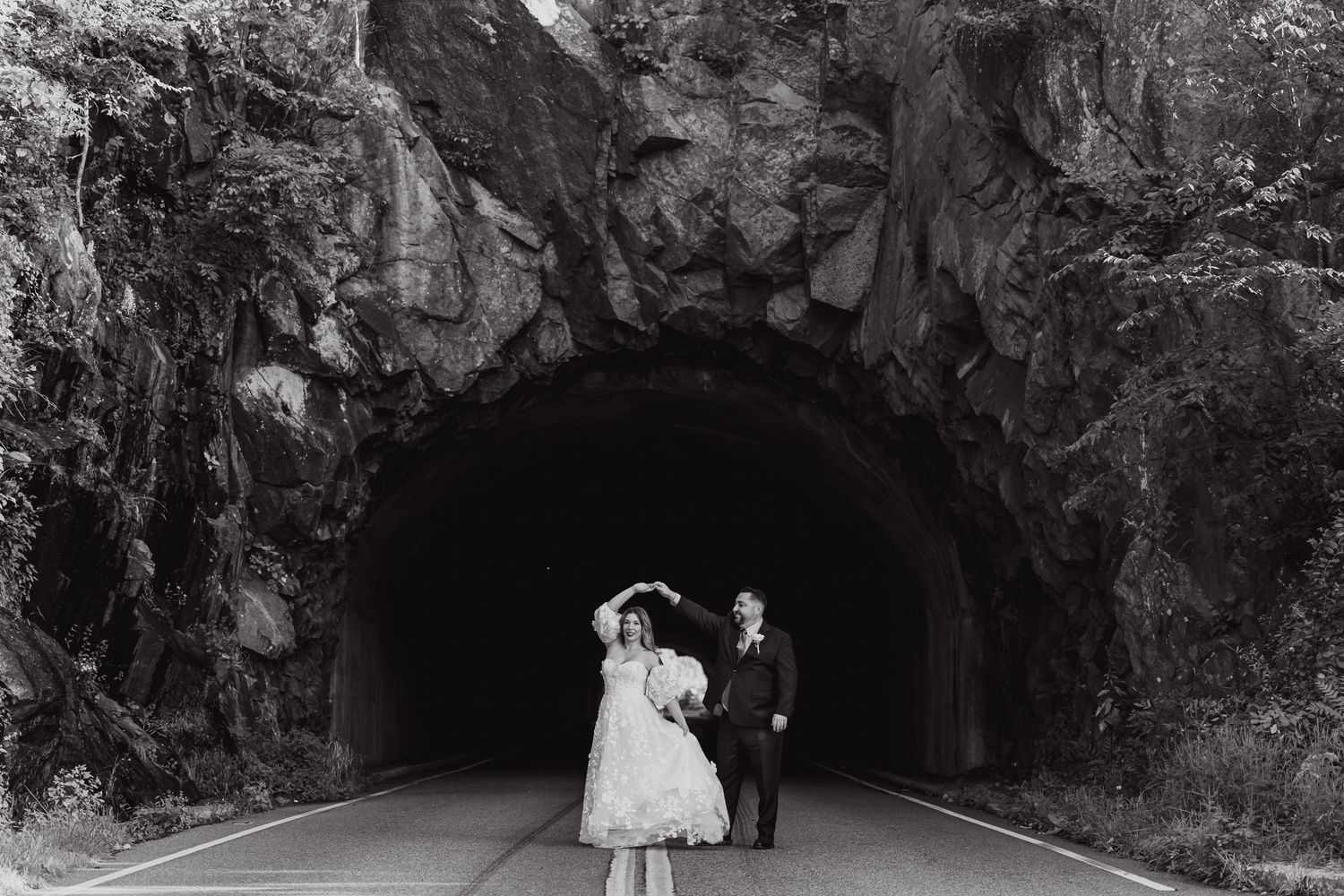 A series of black and white wedding photos showing couples in a cave-like setting with dramatic rock formations.