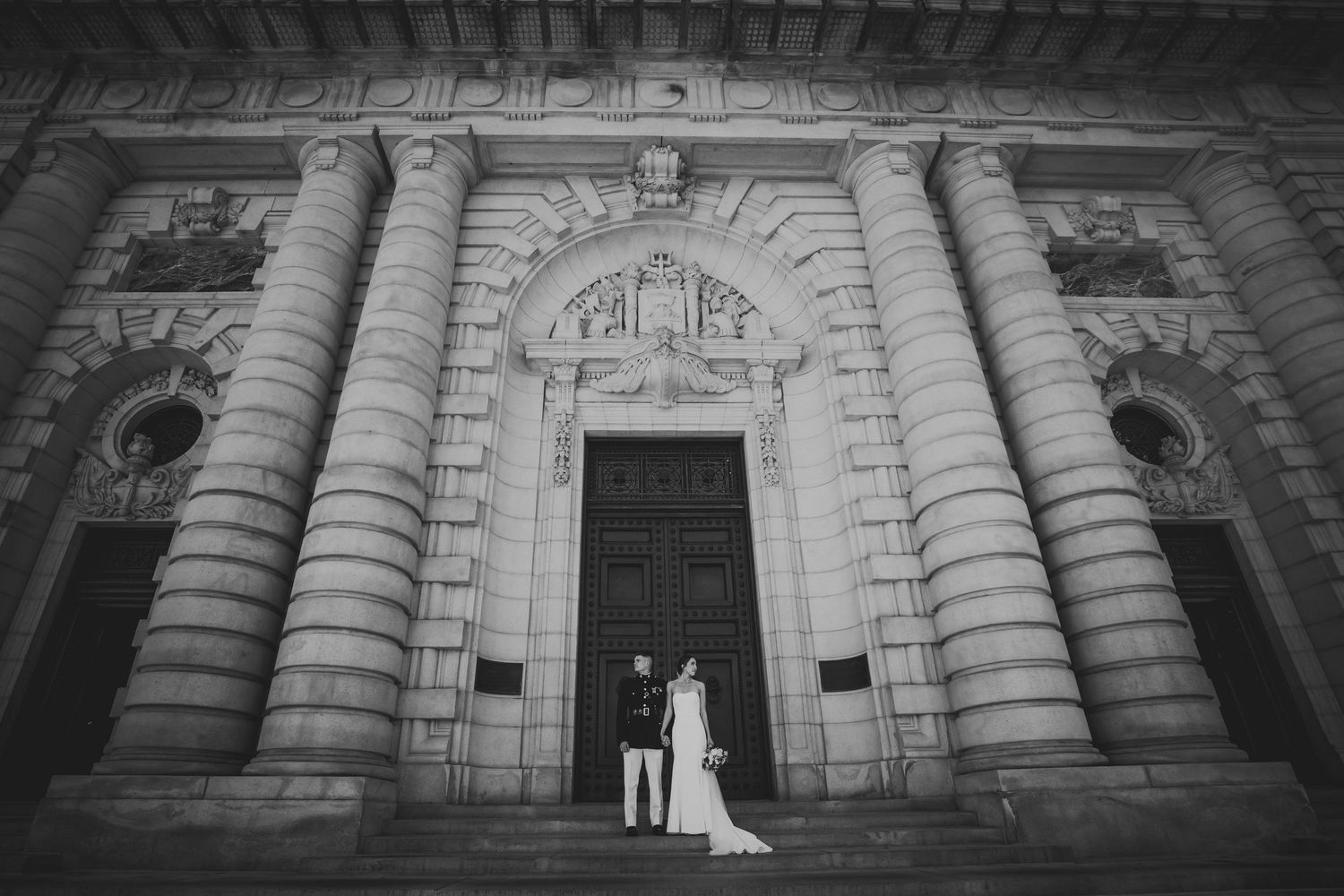 Black and white architectural photos of a grand building entrance with stone columns and wedding couple silhouettes.