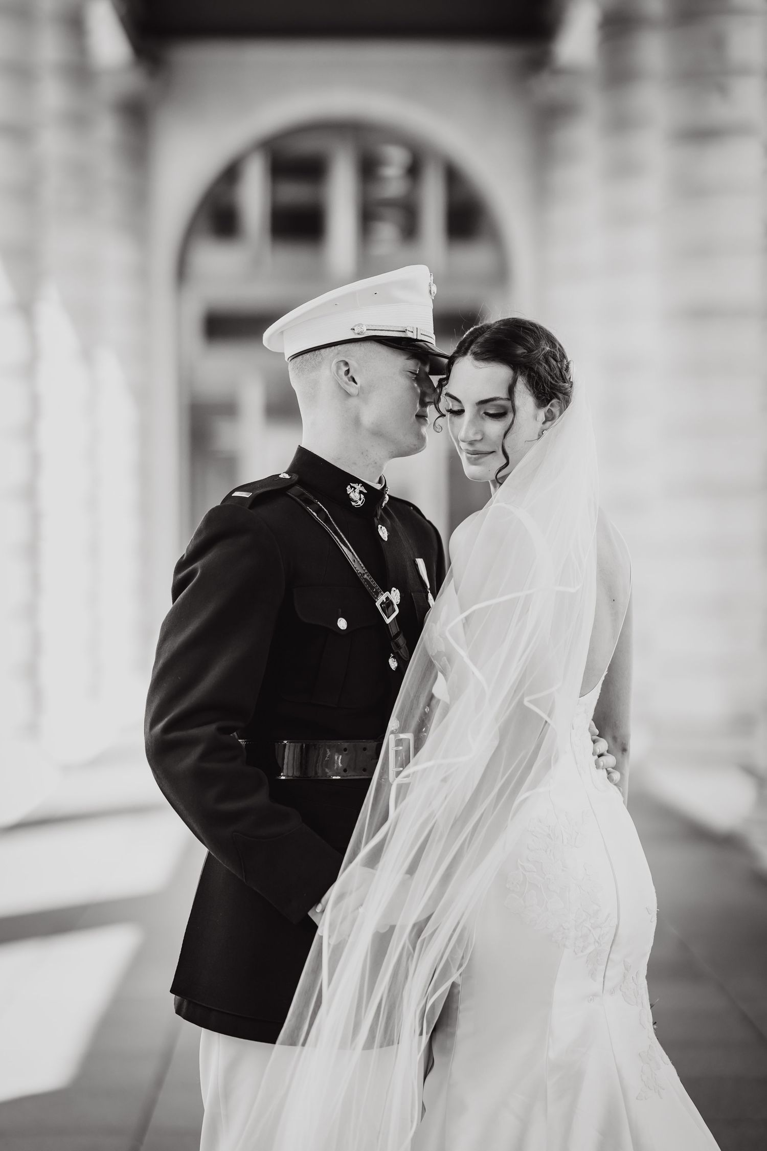 Black and white wedding photos show romantic moments between newlyweds during their outdoor ceremony.