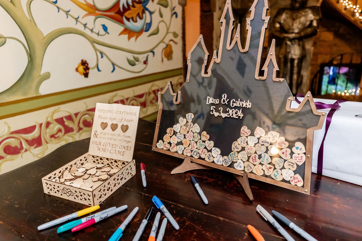 Wedding guest book alternative with castle design and colored markers on display.