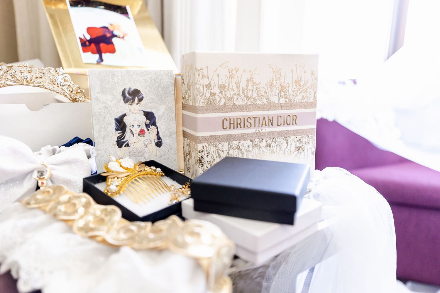 Elegant wedding details with boxes and gold accessories on white lace.
