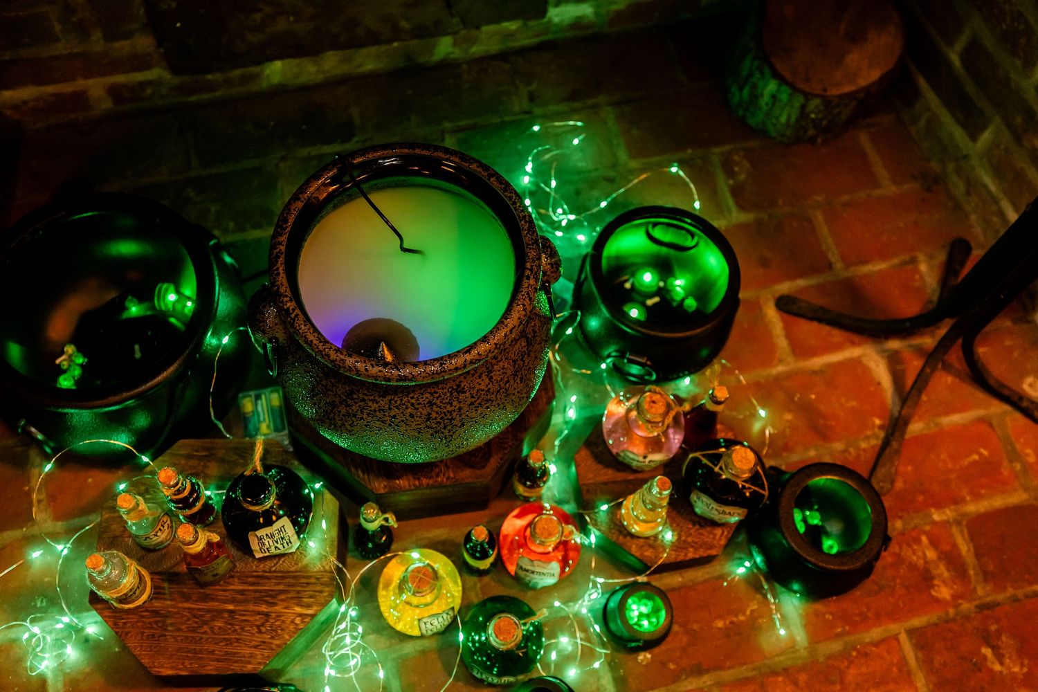 Decorative green lighting illuminates table settings and ornaments at evening reception.