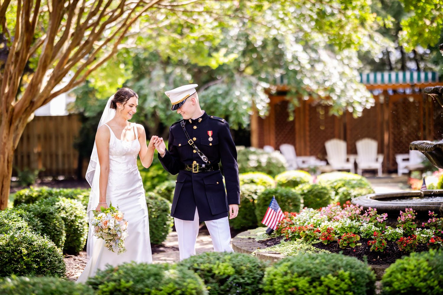 Outdoor garden wedding venue with lush greenery and flowering trees creating a romantic backdrop.