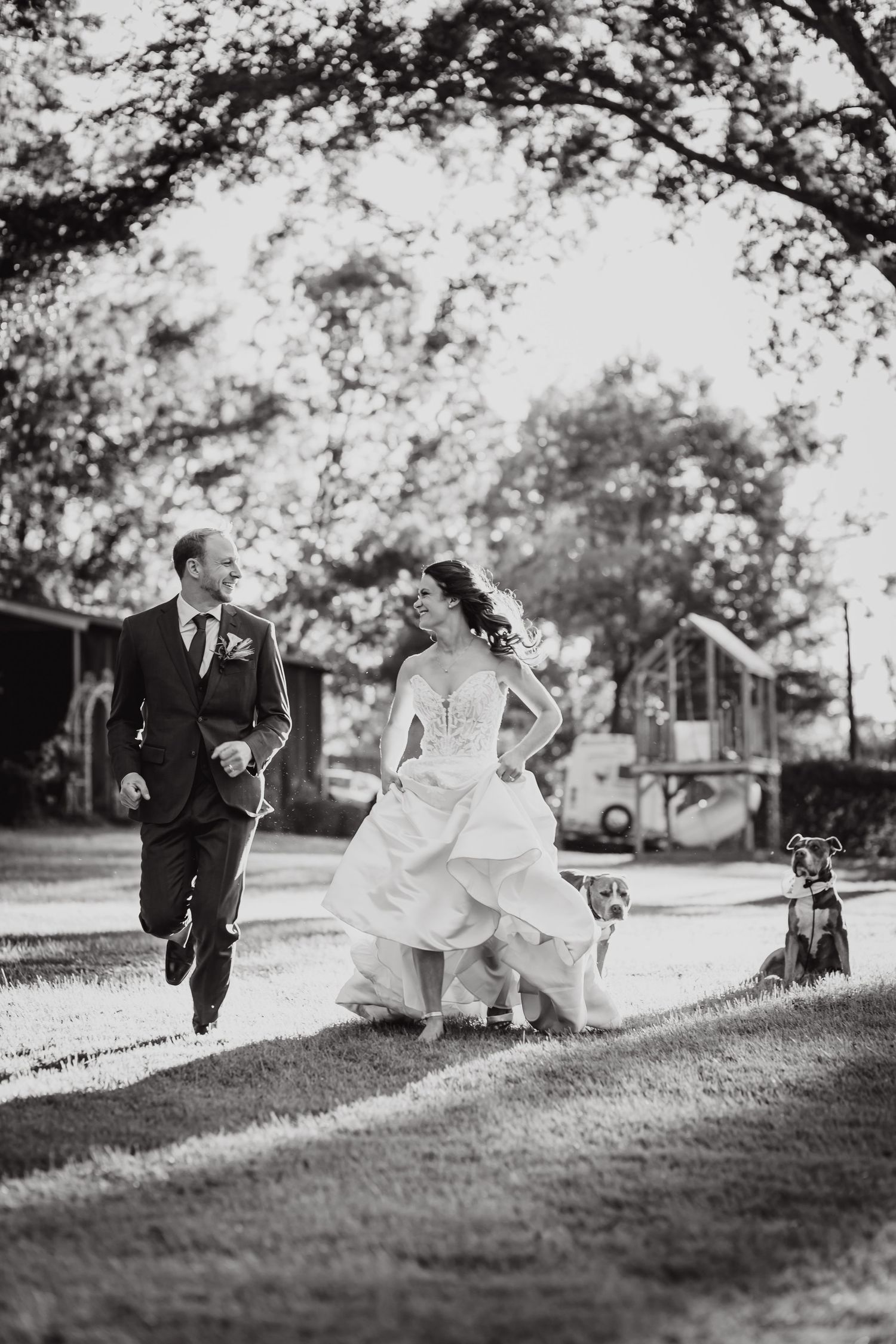 Black and white photo sequence showing a couple playfully running and tumbling down a grassy hill at their wedding.