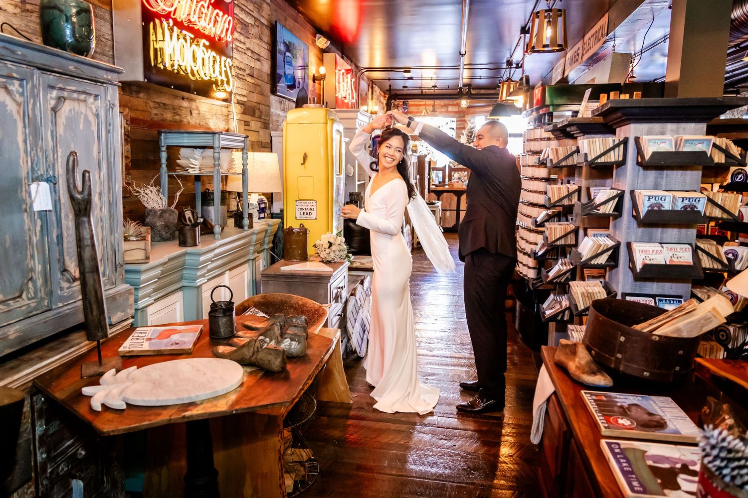A couple explores a vintage bar with wooden decor and antique displays.