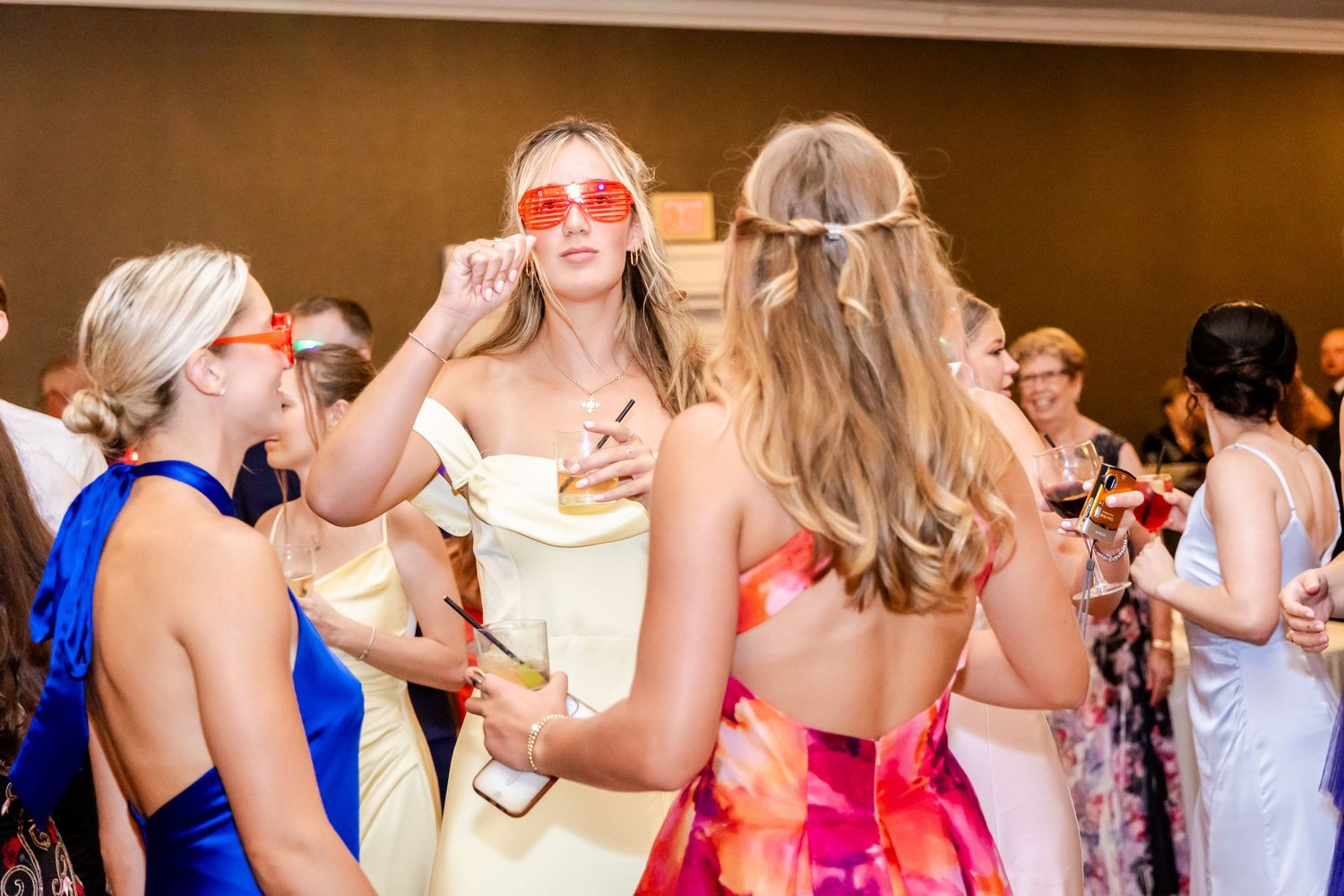 Wedding guests dancing and celebrating on the dance floor at a reception.