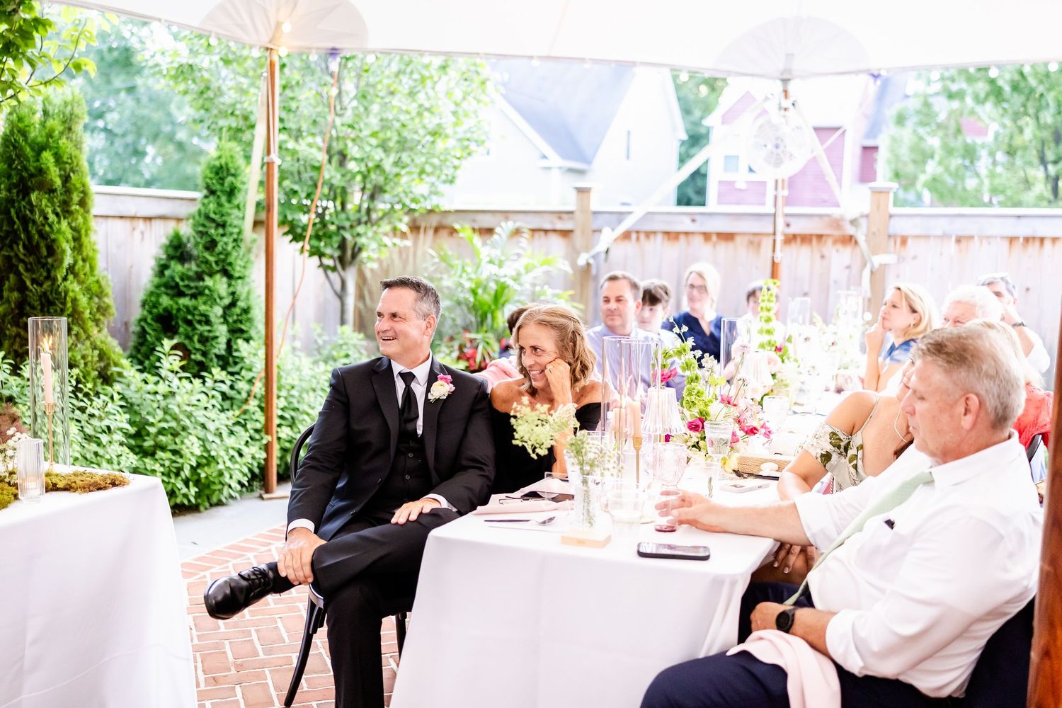 Guests enjoying drinks and conversation at an outdoor garden party.