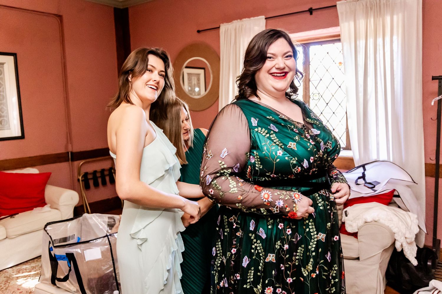 Wedding preparation scene showing joyful moments in a red-walled room.