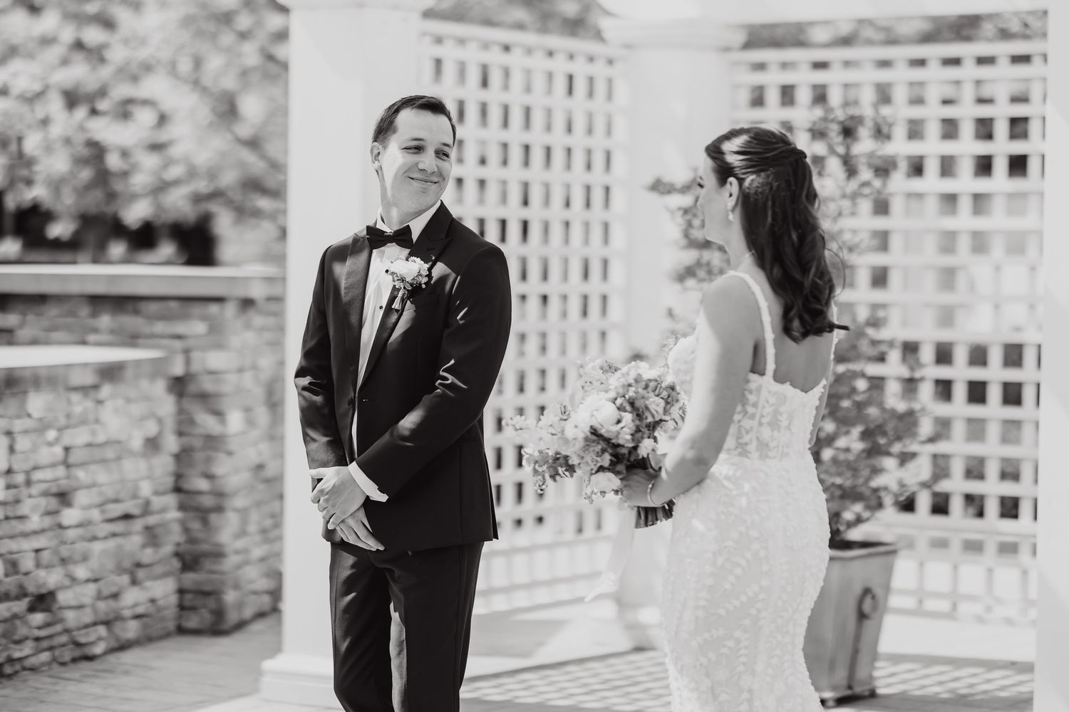 Black and white wedding photo collage showing romantic moments between newlyweds in an outdoor garden setting.
