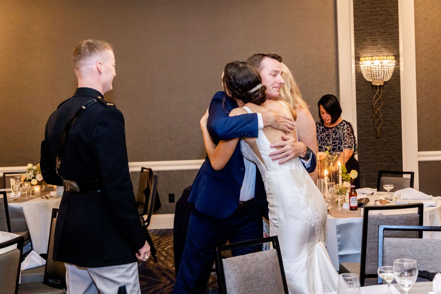 Emotional moment shared between wedding attendees during reception celebration.