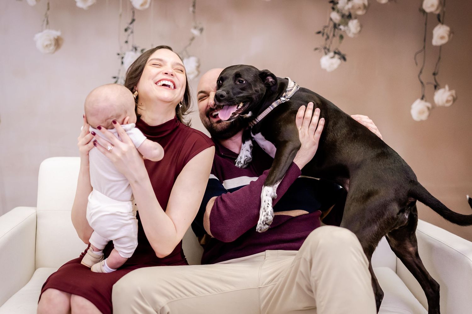 A heartwarming sequence of photos showing a baby and black dog interacting and playing together at home.