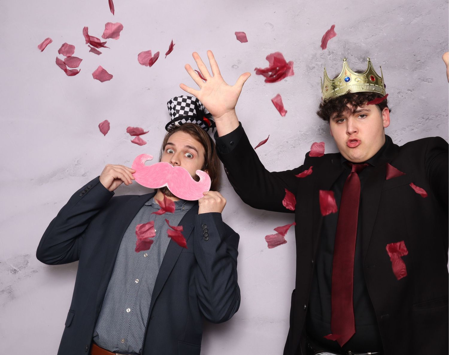 Fun photo booth sequence with red confetti and props against grey backdrop.