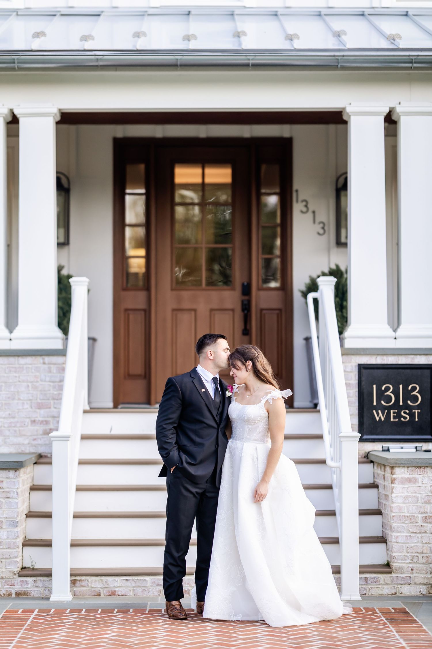 Romantic wedding portraits taken on white columned porch with house number 1313.