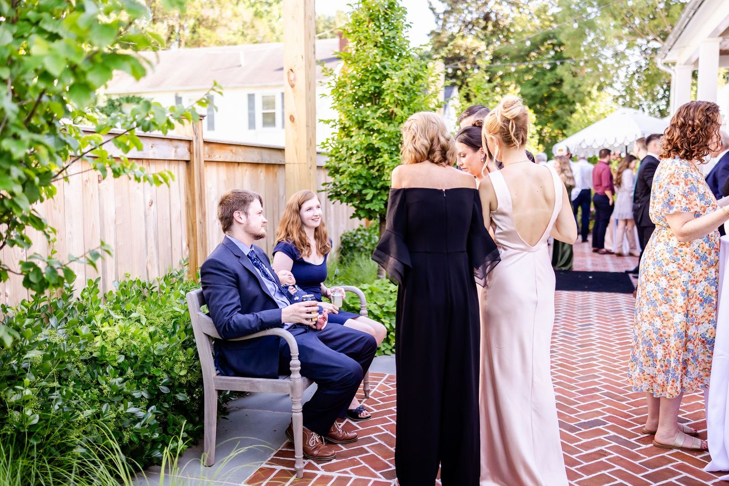 Outdoor wedding ceremony seating arranged in rows with guests gathering.