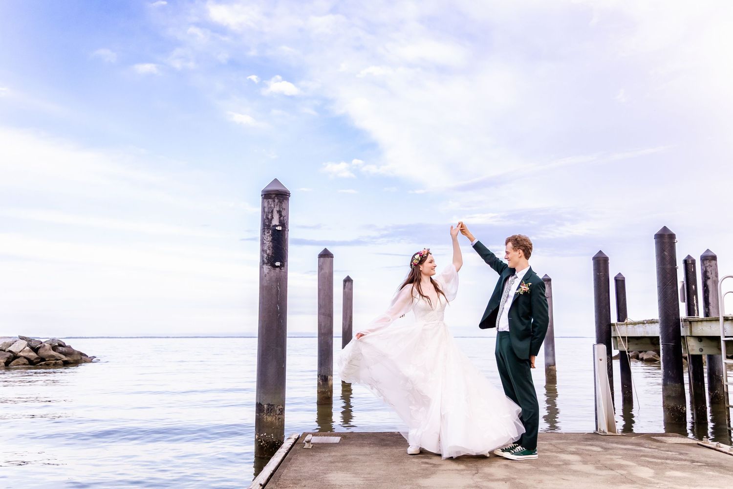 A panoramic collage of wedding photos showing couples on a wooden pier overlooking a beach at sunset.
