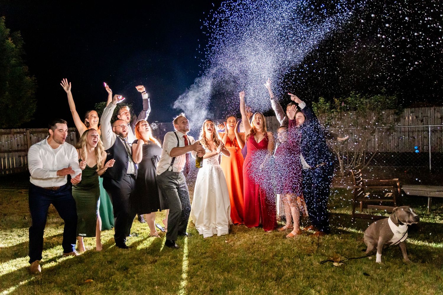 Wedding celebration at night with sparklers creating magical light trails in the darkness.