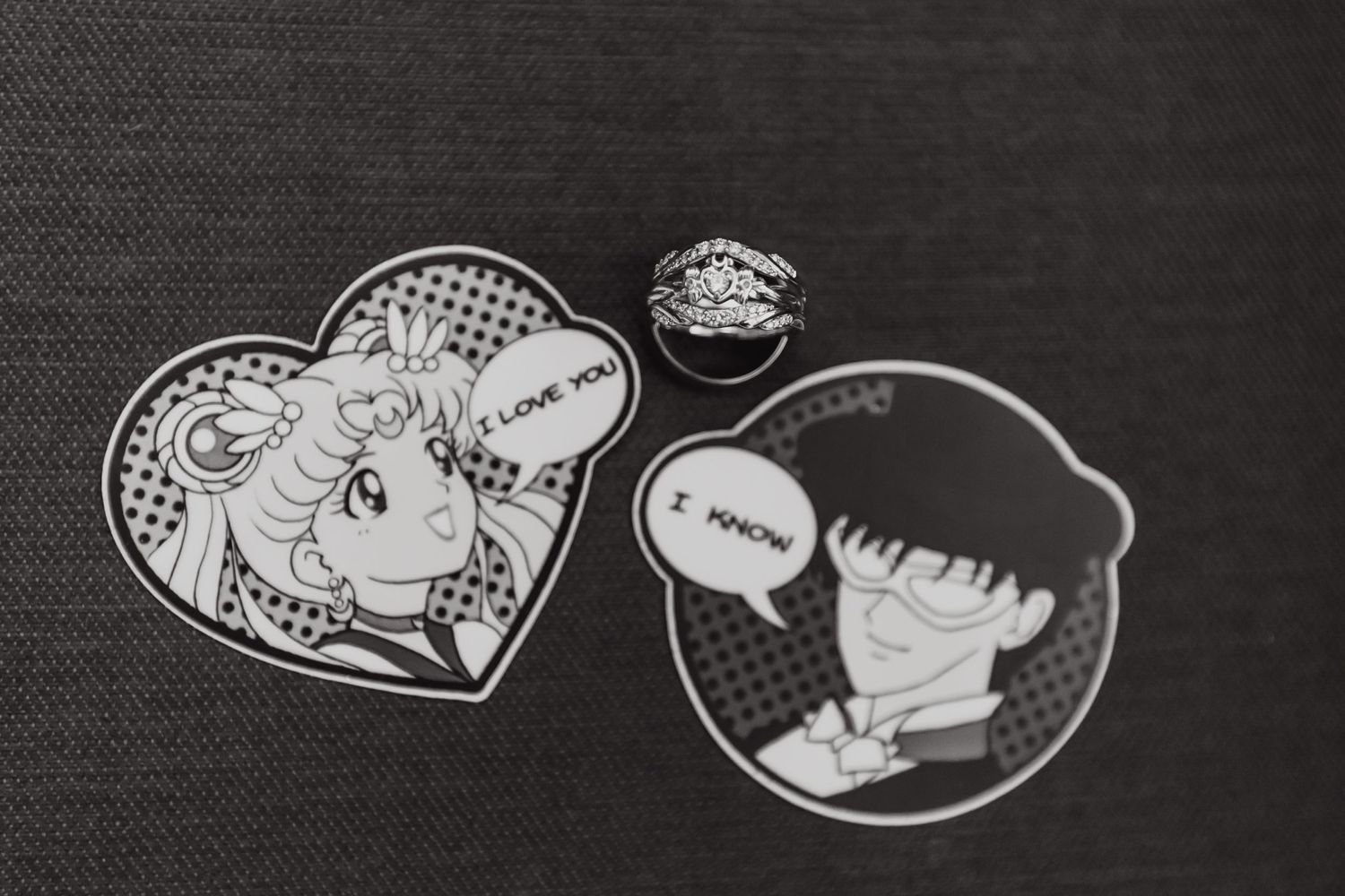 Black and white anime character stickers featuring heart-shaped designs on a dark textured background.