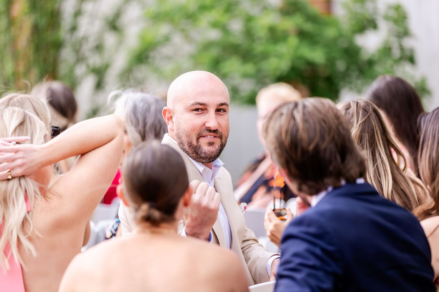 Wedding guests enjoying an outdoor celebration on a sunny day.