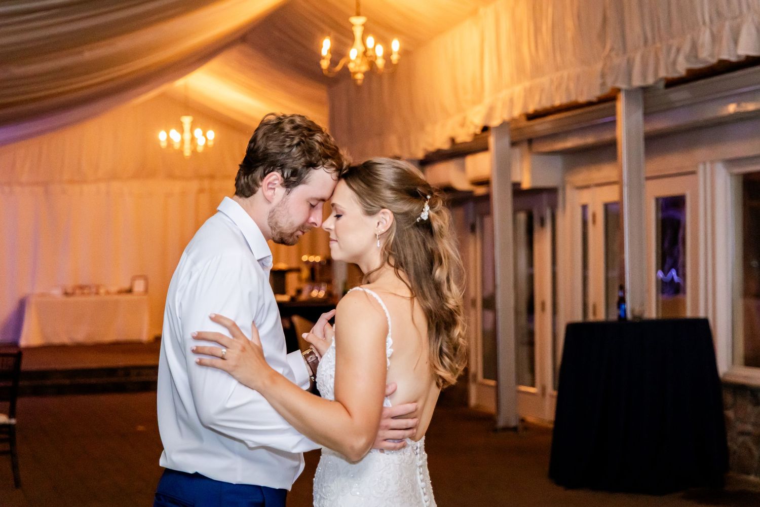 Romantic dance moments captured during an elegantly lit wedding reception.