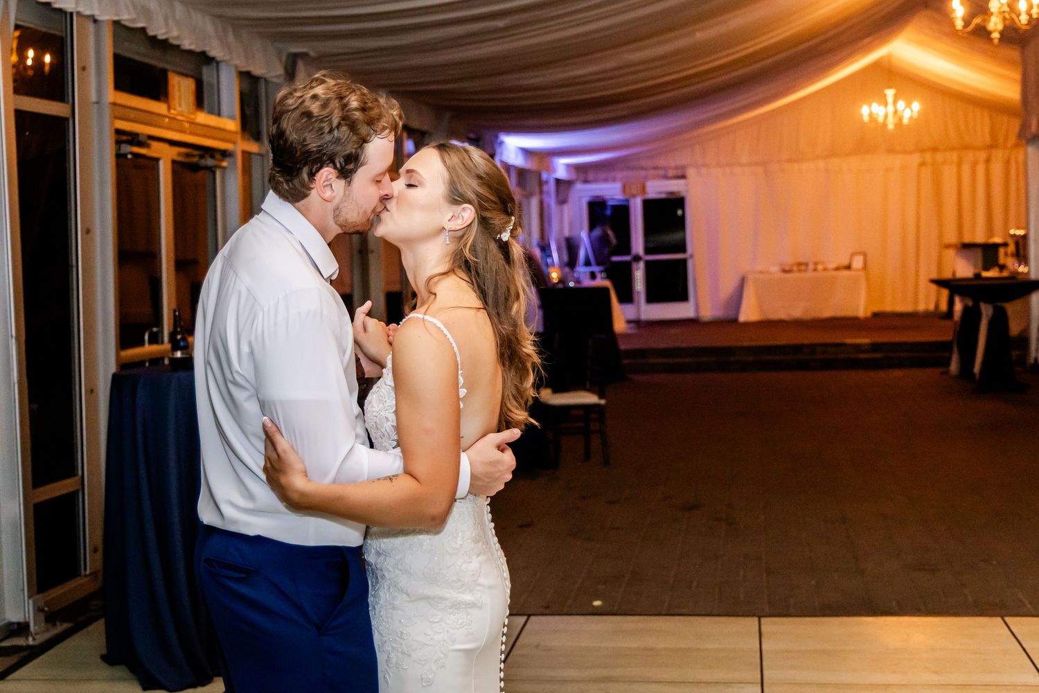 Couples share intimate dances during wedding reception in beautifully lit venue.