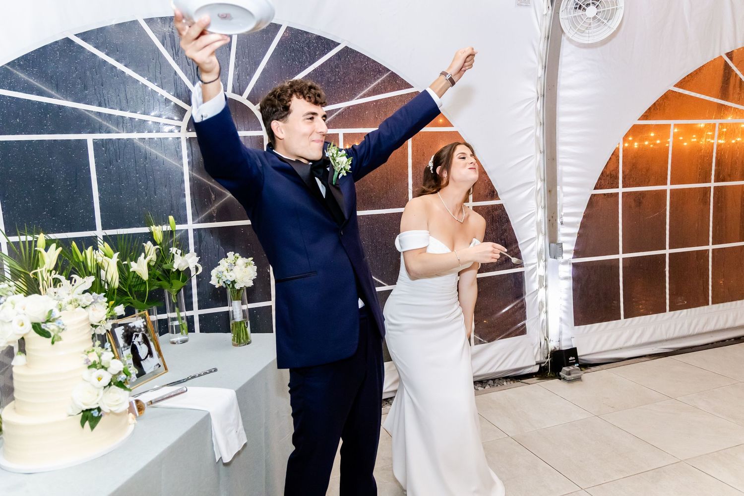 Couple sharing romantic dance moves in an elegant wedding reception space.
