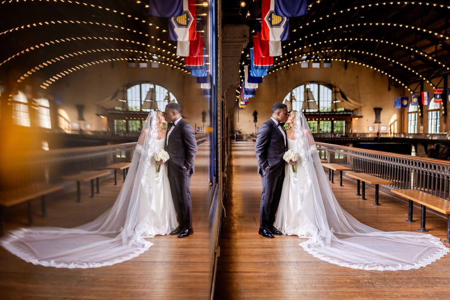 Bride and groom share a romantic mirror reflection moment in an elegant wedding venue with arched ceilings and warm lights.