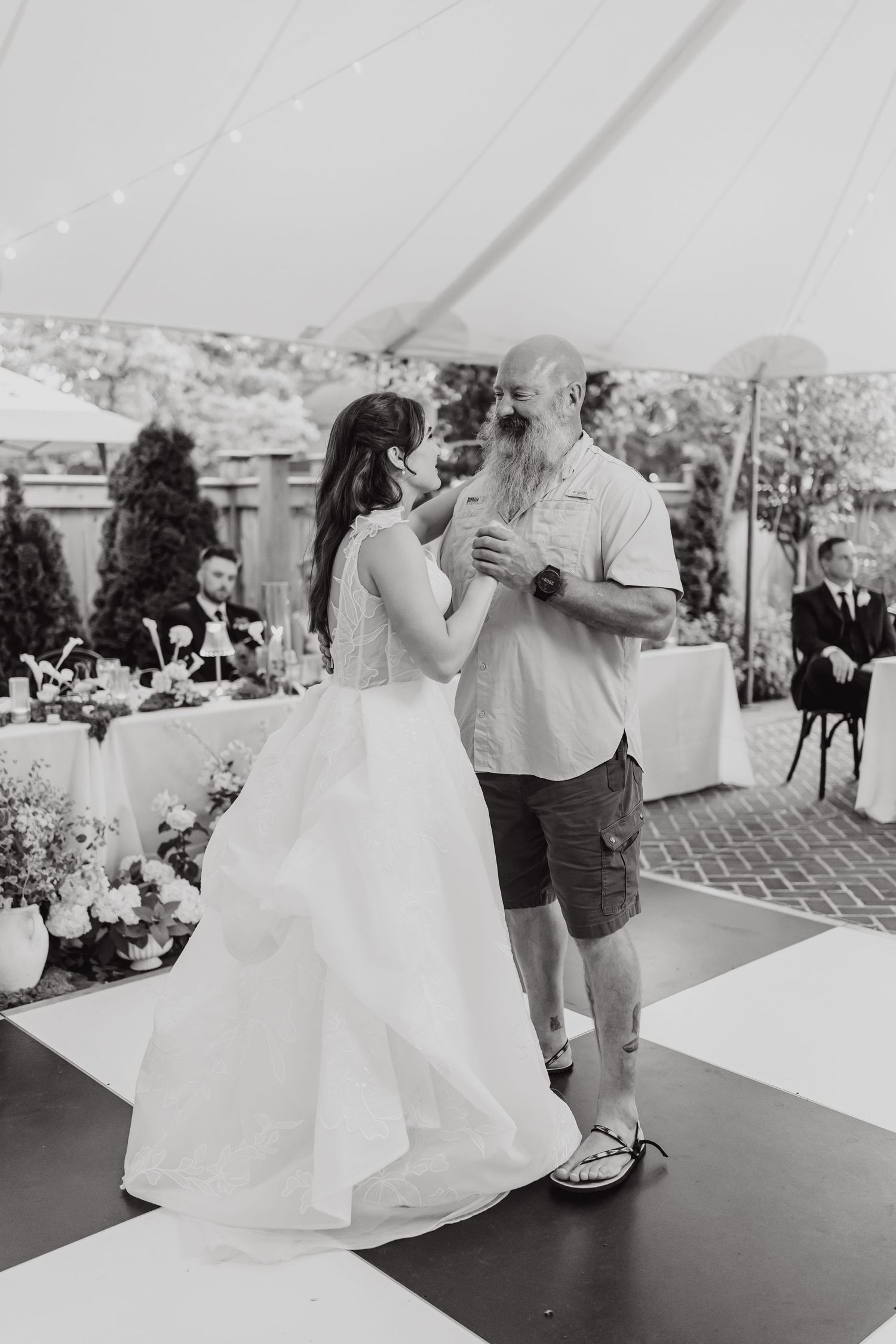 Black and white photos show couples dancing at a wedding reception under a white tent.