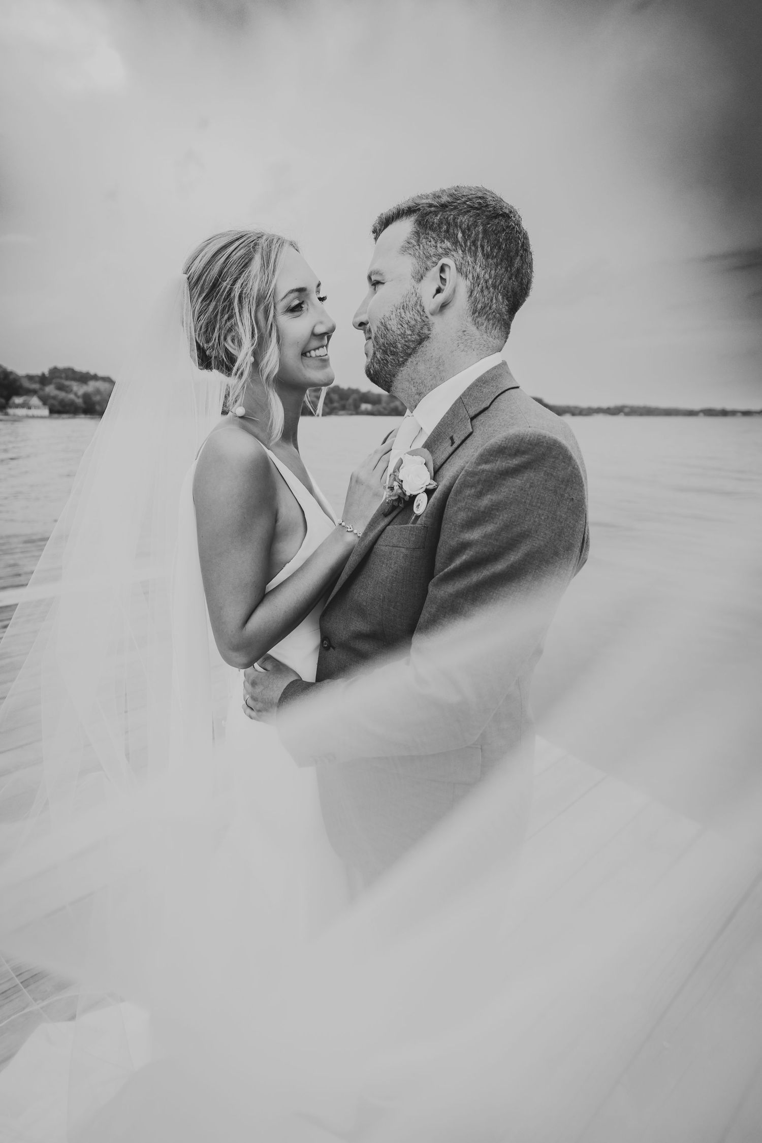 Black and white romantic portraits of a couple sharing intimate moments on their wedding day.