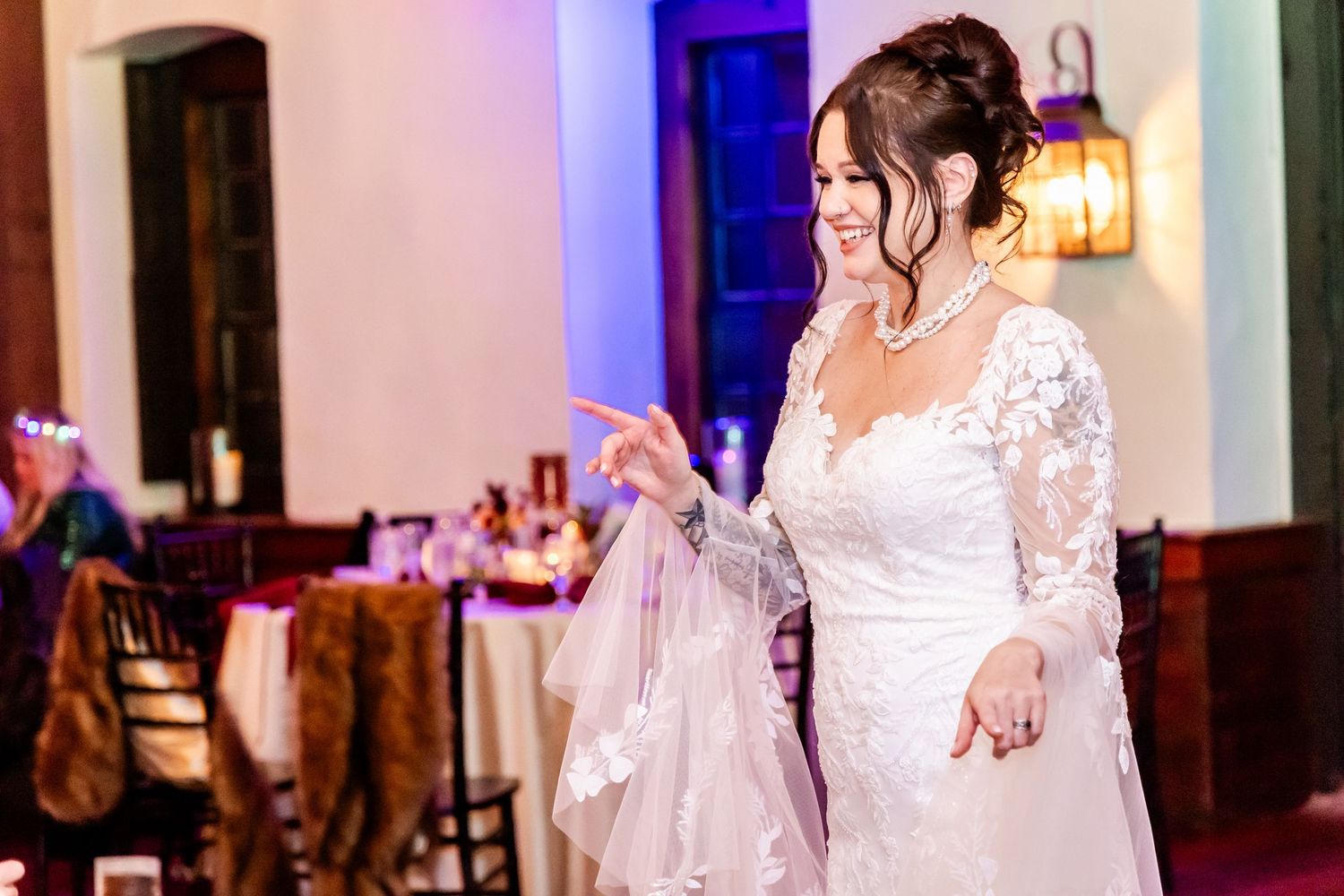 Guests enjoying themselves on the dance floor during an evening wedding reception.