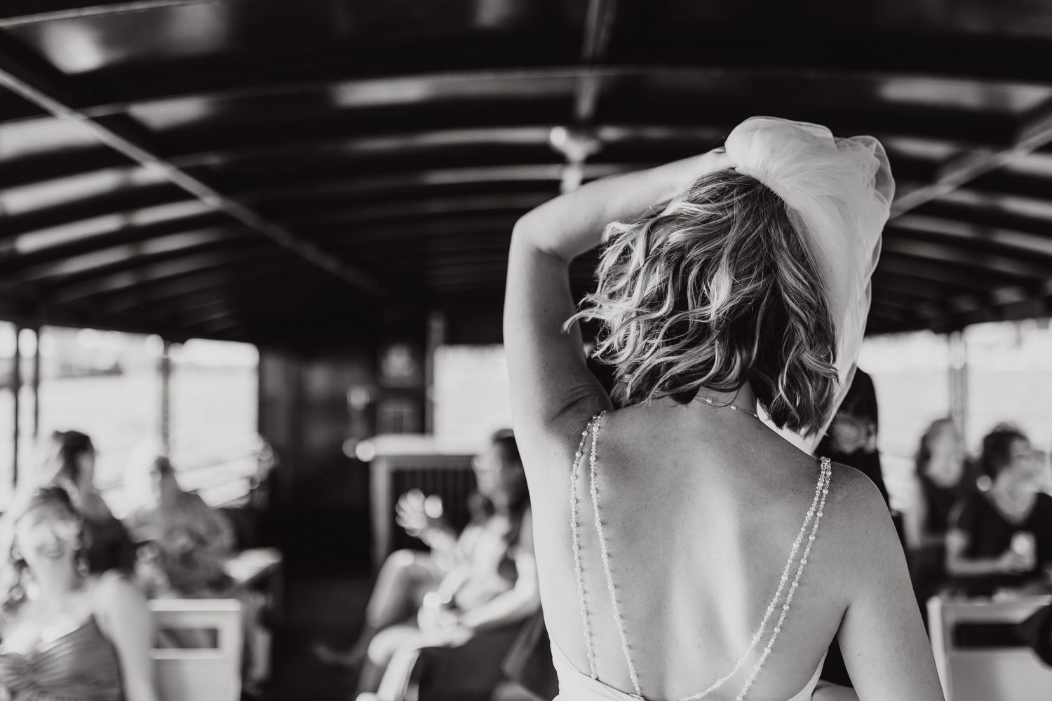 A series of black and white photos showing exercise trainers guiding clients through workout routines in a gym.