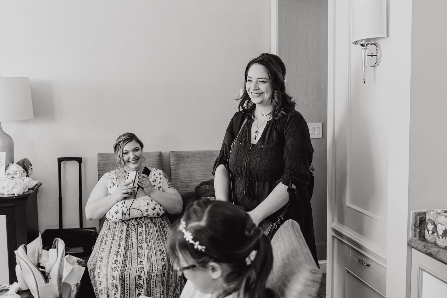 A candid moment during wedding preparations in a bright interior room.