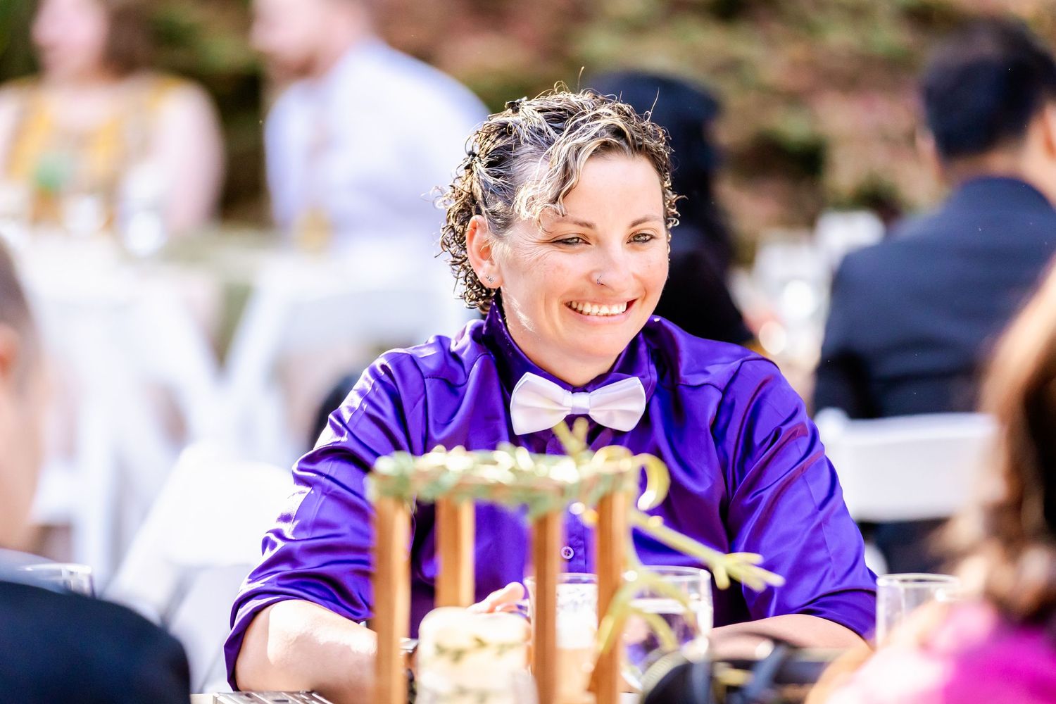 Guest enjoying a festive outdoor celebration in purple attire.